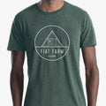 Green t-shirt with 'Fiat Farm' logo worn by a person on a white background
