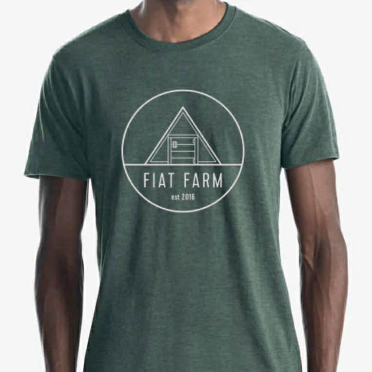Green t-shirt with 'Fiat Farm' logo worn by a person on a white background