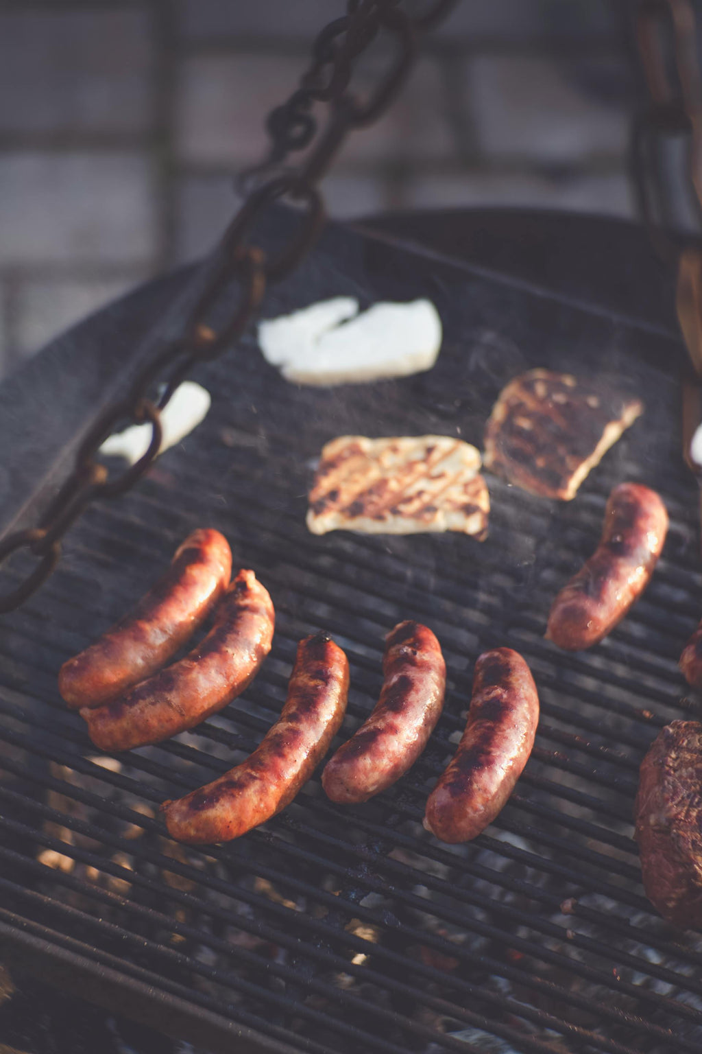 Grilled sausages and vegetables on a barbecue grill